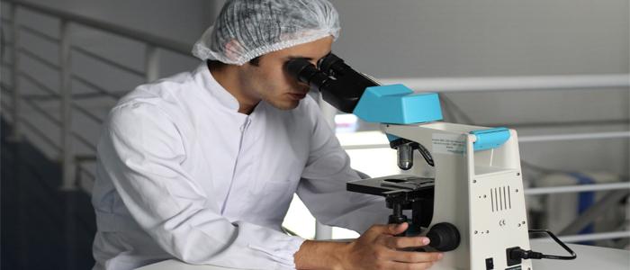 A researcher uses a microscope to study cells.